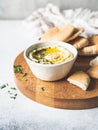 Traditional Homemade chick pea hummus, drizzled with olive oil and fresh parsley and fresh pita slices on wood cutting board. Copy Royalty Free Stock Photo