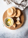 Traditional Homemade chick pea hummus, drizzled with olive oil and fresh parsley and fresh pita slices on wood cutting board. Copy Royalty Free Stock Photo