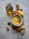 Traditional Homemade chick pea hummus, drizzled with olive oil and fresh parsley and fresh pita slices on wood cutting board on Royalty Free Stock Photo