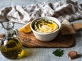 Traditional Homemade chick pea hummus, drizzled with olive oil and fresh parsley and fresh pita slices on wood cutting board on Royalty Free Stock Photo