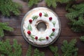 Traditional homemade Christmas cake with garnish cranberry and rosemary on decorative plate. Top view with space for text Royalty Free Stock Photo