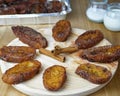 Traditional homemade and Delicious Spanish Torrijas making a circle and three cinnamon sticks in the middle on a round wooden