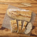 Traditional homemade french baguette bread with slices over wooden table Royalty Free Stock Photo