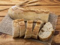 Traditional homemade french baguette bread with slices over wooden table Royalty Free Stock Photo