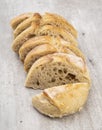 Traditional homemade french baguette bread slices over wooden table Royalty Free Stock Photo