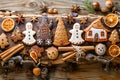 Traditional Homemade Gingerbread Houses, Cookies, and Christmas Spices on Rustic Wooden Background for Festive Holiday Baking Royalty Free Stock Photo