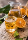 Traditional homemade orange liqueur limoncello and fresh citrus on a wooden table Royalty Free Stock Photo