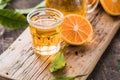 Traditional homemade orange liqueur limoncello and fresh citrus on a wooden table Royalty Free Stock Photo