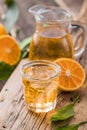 Traditional homemade orange liqueur limoncello and fresh citrus on a wooden table Royalty Free Stock Photo