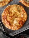 Traditional homemade Romanian and Moldovan round pies - Placinta, served on a plate, dark background. Bakery products