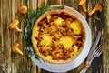 Traditional homemade swedish pie - quiche with chanterelle mushrooms, cheese and rosemary decorated with vintage kinife and fork Royalty Free Stock Photo