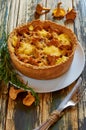 Traditional homemade swedish pie - quiche with chanterelle mushrooms, cheese and rosemary decorated with vintage knife and fork Royalty Free Stock Photo