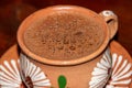 Traditional hot chocolate in a clay mug