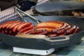 Prague, Czech Republic 2019:Traditional hot dog preparation on coal fire on the street during the Christmas market Royalty Free Stock Photo