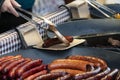 Prague, Czech Republic 2019:Traditional hot dog preparation on coal fire on the street during the Christmas market Royalty Free Stock Photo