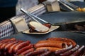 Prague, Czech Republic 2019:Traditional hot dog preparation on coal fire on the street during the Christmas market Royalty Free Stock Photo