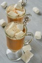 Traditional hot winter drink or Christmas cocktail - spicy latte or cocoa in the glasses with marshmallows on the gray background Royalty Free Stock Photo