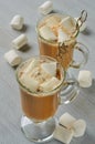 Traditional hot winter drink - latte or cocoa in the glasses with marshmallows on the gray concrete background Royalty Free Stock Photo