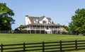 Traditional House Beyond Green Lawn and Black Fence