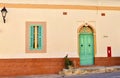 Traditional house countryside of Zejtun, Malta, with a brightly painted green door and a letterbox