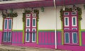 Traditional house facade with colorful painted doors and wooden panelling, Salento. Columbia