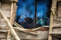 Traditional house Korowai people tribe. View inside the house through the window