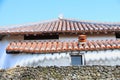 Traditional House with Orange Tiles and Shisa in Tsuboya Yachimun Street, Naha, Okinawa, Japan Royalty Free Stock Photo