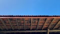 traditional house roof made of red tiles with blue sky background Royalty Free Stock Photo