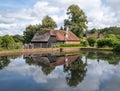 Traditional house is situated near a tranquil pond in Burwash, United Kindom Royalty Free Stock Photo