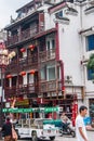 Traditional house with wooden balconies in street scene, Guilin, China