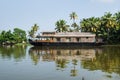 Traditional houseboat in the Kerala backwaters along palm tree coastline, Alappuzha, Alleppey, India Royalty Free Stock Photo