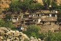 Traditional Houses on the Green Forest Rocks in Pakistani Mountains Royalty Free Stock Photo