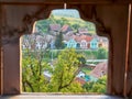 Traditional houses in Transylvania, Romania, seen through a frame in the Alma Vii fortified church stone wall Royalty Free Stock Photo