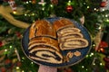 traditional hungarian christmas cookie calles bejgli filled with walnut and poppy seed with christmas tree background
