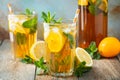 Traditional iced tea with lemon and ice in tall glasses on a wooden rustic table Royalty Free Stock Photo