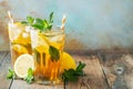 Traditional iced tea with lemon and ice in tall glasses on a wooden rustic table. With copy space Royalty Free Stock Photo