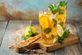 Traditional iced tea with lemon and ice in tall glasses on a wooden rustic table. With copy space Royalty Free Stock Photo