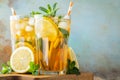 Traditional iced tea with lemon and ice in tall glasses on a wooden rustic table. With copy space Royalty Free Stock Photo