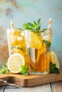 Traditional iced tea with lemon and ice in tall glasses on a wooden rustic table. With copy space Royalty Free Stock Photo