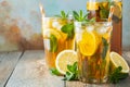 Traditional iced tea with lemon and ice in tall glasses on a wooden rustic table. With copy space Royalty Free Stock Photo