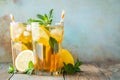 Traditional iced tea with lemon and ice in tall glasses on a wooden rustic table. With copy space Royalty Free Stock Photo