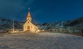 A traditional icelandic church stands proud at the foot of a small mountain, in southern Iceland.