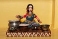 traditional indian cooking: clay figurine of a woman preparing delicious ddosas