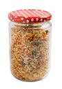 Traditional indian deep fried salty dish - chivda or mixture or farsan in a glass jar isolated on white background.