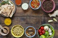 Traditional Indian dining table. Indian cooking. Various vegetarian dishes made of lentils and local snacks in multi-colored bowls Royalty Free Stock Photo