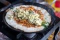Traditional indian dosa with potato cooking on skillet