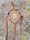 Traditional Indian dreamcatcher hanging outside on a chain link fence