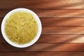 Traditional Indian food Pongal sweets in white bowl on wooden background Royalty Free Stock Photo