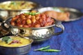 Traditional Indian home-cooked dinner. dishes of national Indian cuisine on a dark blue background. rice, dal, sabji, pakora. top