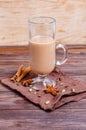 Traditional indian masala chai tea in a tall glass cup on a dark napkin with spices Royalty Free Stock Photo